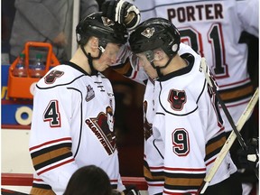 Hitmen Micheal Zipp (L) and Matt Dorsey touch heads after losing to the Pats 5-1 during WHL playoff action between the Regina Pats and the Calgary Hitmen in Calgary, Alta on Thursday March 30, 2017. The Pats swept the Hitmen.