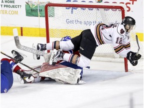 Calgary Hitmen's Mark Kastelic, collides with Edmonton Oil Kings goalie Patrick Dea at the Scotiabank Saddledome in Calgary on Sunday, March 12, 2017. (Leah Hennel)