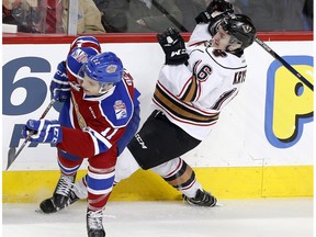 Edmonton Oil Kings Adam Berg, left, collides with Calgary Hitmen Jake Kryski in WHL action at the Scotiabank Saddledome in Calgary, Alberta, on Sunday, March 12, 2017. Kryski scored two goals for the Hitmen in a 5-2 loss at the Regina Pats in Game 1 of their first-round playoff series Friday in Regina, Sask.