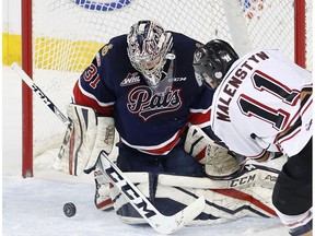 Calgary Hitmen's Beck Malenstyn takes a shot on Regina Pats goalie Tyler Brown at the Scotiabank Saddledome in Calgary on Feb. 8, 2017. (Leah Hennel)