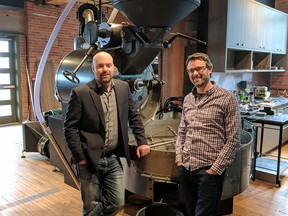 Jesse Messom, owner of Bigfoot Industrial Services, with Phil Robertson of Phil & Sebastian's, and the roaster that Bigfoot refurbished for the coffee company.