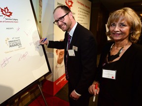 Immigrant Services Calgary CEO Krystyna Biel and ISC chair of the board Paul Avender sign the welcome board. The 21st Annual Immigrants of Distinction Awards (IDA) kicked at The Westin Hotel in Calgary, Alta., on March 10, 2017. Hundreds of colourful gowns and sharp suits filled the room as guests including the likes of Jason Kenney and Naheed Nenshi arrived for the prestigious event. Ryan McLeod/Postmedia Network