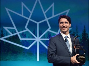 Prime Minister Justin Trudeau receives the CERAWeek Global Energy and Environment Leadership Award prior to addressing and taking part in a question and answer session at the CERAWeek Global Energy and Environment Leadership Award Dinner in Houston, Texas, on Thursday, March 9, 2017. CANADIAN PRESS/Sean Kilpatrick ORG XMIT: SKP115b