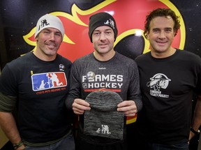 (L-R) Cvet's Pets founder Chris Cvetkovic, Calgary Flames goalie and Moose's Troops frontman Brian Elliott, and Canadian Legacy Project president and CEO David Howard at the Scotiabank Saddledome in Calgary on March 8, 2017. Cvetkovic, a former long snapper for the Winnipeg Blue Bombers met Elliott for the first time, with Cvet's Pets and Moose's Troops having a shared umbrella organization in the Canadian Legacy Project.