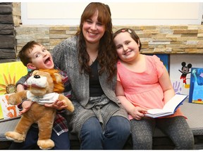 Laura (R), her mother Jennifer and brother Stuart 6 yrs, pose at the Children's Wish office in Calgary Sunon Wednesday March 1, 2017. Laura had a brain tumour which was removed but the result of which is legal blindness. She went to Harry Potter World recently due to the kindness of the Children's Wish. Jim Wells/Postmedia