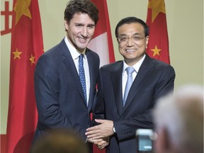 Chinese Premier Li Keqiang, and Canadian Prime Minister Justin Trudeau shake hands after speaking to a business luncheon Friday, September 23, 2016 in Montreal.