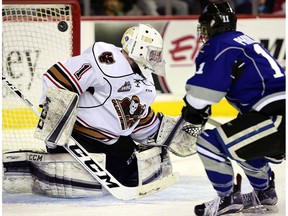 Matthew Phillips scores his third of the game on Hitmen goalie Trevor Martin as the Calgary Hitmen hit the ice against the Victoria Royals on January 20 in Western Hockey League regular season action.