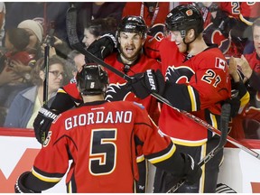 Michael Frolik, Dougie Hamilton and Mark Giordano of the Calgary Flames celebrate one of four first-period goals on the way to a 5-2 win over the New York Islanders in Calgary on Sunday, March 5, 2017. (Lyle Aspinall)