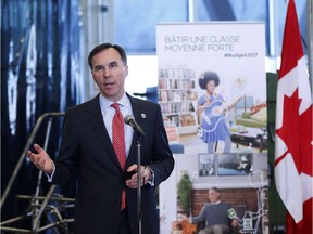 Federal Finance Minister Bill Morneau answers questions at a news conference after touring the Southern Alberta Institute of Technology in Calgary on Monday.