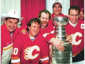 Calgary Flames head coach Terry Crisp, Mike Vernon,Lanny McDonald, Tim Hunter and Jim Peplinski pose with the Stanley Cup in 1989, the first year the Flames franchise posted an eight-win stretch since moving to Calgary. (File)