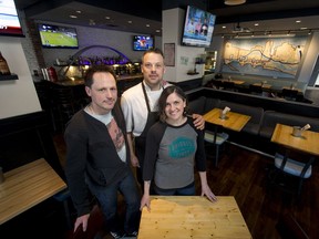 Chef Tyler Ballance (centre) stands with restaurant co-owners Larry and Denise Scammell at Bridges on First in the Bridgeland area of Calgary.