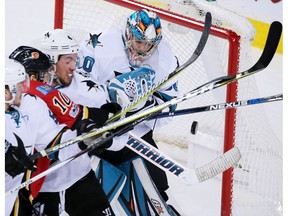 San Jose Sharks goaltender Aaron Dell struggles to stop a Calgary Flames scoring chance at the Scotiabank Saddledome in Calgary on Jan. 11, 2017. Calgary won the game 3-2. (Gavin Young)