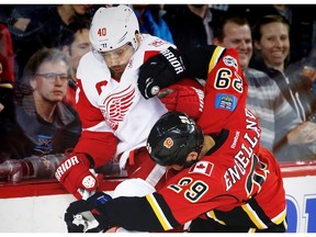 Detroit Red Wings Henrik Zetterberg battles against Deryk Engelland of the Calgary Flames during NHL hockey in Calgary, Alta., on Friday, March 3, 2017.