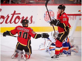 Calgary Flames' Kris Versteeg celebrates with teammate Sam Bennett after scoring on New York Islanders goalie Jean-Francois Berube in Calgary on Sunday, March 5, 2017. (Al Charest)