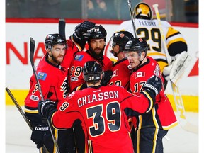 Calgary Flames' Matt Stajan celebrates with teammates after scoring on Marc-Andre Fleury of the Pittsburgh Penguins in Calgary on Monday, March 13, 2017. (Al Charest)