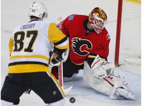 Calgary Flames Brian Elliott stops Sidney Crosby of the Pittsburgh Penguins in overtime in Calgary on Monday, March 13, 2017. (Al Charest)