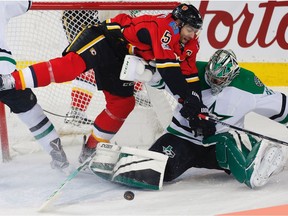 Calgary Flames Mark Giordano collides with Kari Lehtonen of the Dallas Stars during NHL hockey in Calgary, Alta., on Friday, March 17, 2017.