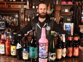 Bottlescrew Bill's general manager Geoff Allan was photographed with a variety of out-of-province beers the Calgary bar sells.