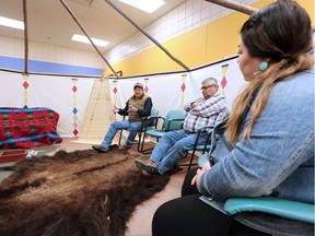 Elders Peter Weasel Moccasin, left and Leroy Heavy Runner sit with school councillor Cara Black Water, right, in Kainai High School's new Elders in Residence program lodge. The school on the Blood Reserve in Southern Alberta believes the innovative program is helping students by connecting them with traditional ways of healing. Gavin Young, Calgary Herald