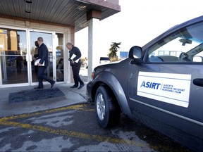 FILE PHOTO: ASIRT investigator arrives at the scene of a the shooting death of Anthony Heffernan at the Super 8 motel at 32 ave and Barlow Trail in Calgary, Alta., on Monday March 16, 2015. Mike Drew/Postmedia