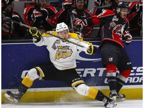 Brandon Wheat Kings' Reid Duke, left, checks Rouyn-Noranda Huskies' Mathieu Boucher in the Memorial Cup in Red Deer on May 21, 2016. The Vegas Golden Knights have signed the forward as the expansion franchise's first player. (The Canadian Press)