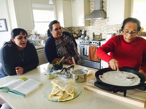 Suja, left, Shantha and Sara George mix up a batch of dosas.