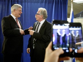 Former Prime Minister Stephen Harper and dinner attendee Sig Zoller chat while being photographed by two cameras at the 66th annual B'nai Brith dinner at Beth Tzedec Synagogue in Calgary on Thursday, March 16, 2017. Harper was the guest of honour at the dinner.