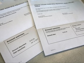 A carbon tax rebate sits next to a bill for the same amount following the recipient's death.
