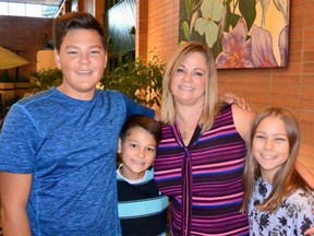 Calgary mom Kerry Nagata is pictured here with her three children Adam (left), Eric and Sydney. A GoFundMe has been started for the family, who lost their family home in a devastating fire Friday.
