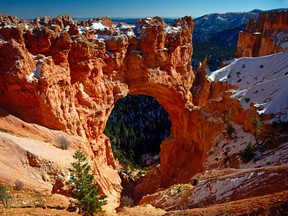 This natural rock bridge can be seen at one of the viewpoints just off the main road. A light dusting of snow adds a nice contrast. For Herald Travel story on Bryce Canyon by Debbie Olsen. Photo credit, Greg Olsen.