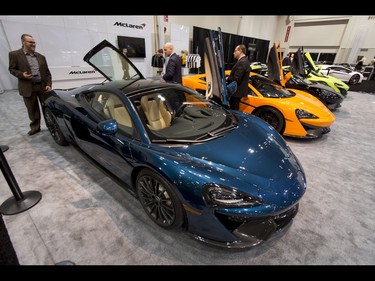 A trio of men wander through a lineup of McLarens during the 18th annual Vehicles and Violins gala at the BMO Centre in Calgary, Alta., on Tuesday, March 14, 2017. Vehicles and Violins is a black-tie preview of the 2017 Calgary International Auto and Truck Show, featuring Calgary Philharmonic Orchestra musicians. Lyle Aspinall/Postmedia Network