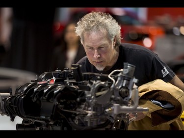 Andy Campbell eyes a Ford 2.3 L DOHC EcoBoost Mustang engine during the 18th annual Vehicles and Violins gala at the BMO Centre in Calgary, Alta., on Tuesday, March 14, 2017. Vehicles and Violins is a black-tie preview of the 2017 Calgary International Auto and Truck Show, featuring Calgary Philharmonic Orchestra musicians. Lyle Aspinall/Postmedia Network