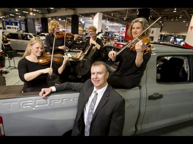 Executive manager Jim Gillespie hangs out with Calgary Philharmonic Orchestra members Mary Jane Vandekerkhove on violin, Barbara Smith on violin, Heather Heron-Mykyte on viola, and Liz Tremblay on cello in the back of a Toyota Tundra during the 18th annual Vehicles and Violins gala at the BMO Centre in Calgary, Alta., on Tuesday, March 14, 2017. Vehicles and Violins is a black-tie preview of the 2017 Calgary International Auto and Truck Show, featuring Calgary Philharmonic Orchestra musicians. Lyle Aspinall/Postmedia Network