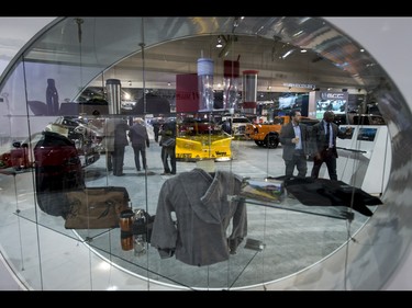 People walk by a Dodge display during the 18th annual Vehicles and Violins gala at the BMO Centre in Calgary, Alta., on Tuesday, March 14, 2017. Vehicles and Violins is a black-tie preview of the 2017 Calgary International Auto and Truck Show, featuring Calgary Philharmonic Orchestra musicians. Lyle Aspinall/Postmedia Network