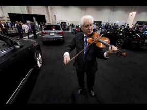 Igor Motchalov plays a violin during the 18th annual Vehicles and Violins gala at the BMO Centre in Calgary, Alta., on Tuesday, March 14, 2017. Vehicles and Violins is a black-tie preview of the 2017 Calgary International Auto and Truck Show, featuring Calgary Philharmonic Orchestra musicians. Lyle Aspinall/Postmedia Network