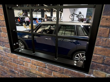 A window offers a peek into the Mini display during the 18th annual Vehicles and Violins gala at the BMO Centre in Calgary, Alta., on Tuesday, March 14, 2017. Vehicles and Violins is a black-tie preview of the 2017 Calgary International Auto and Truck Show, featuring Calgary Philharmonic Orchestra musicians. Lyle Aspinall/Postmedia Network