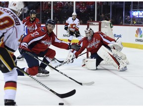 Washington Capitals defenceman Karl Alzner and goalie Braden Holtby prepare for a shot from Calgary Flames right winger Kris Versteeg in Washington on Tuesday, March 21, 2017. (Molly Riley/AP Photo)