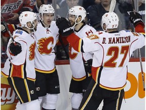 Flames celebrate a goal against the Winnipeg Jets on March 11.