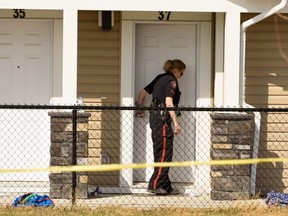 Police investigate at a home on Redstone Circle N.E. where two young children fell from a three-storey window.