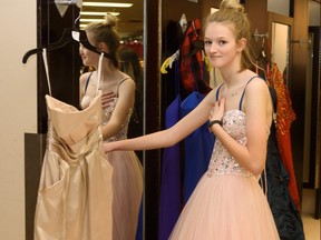 Bryanna Stautzenberger decides on the perfect dress for grad after trying it on at the Gown Town sale in Calgary on Sunday, April 9, 2017. This 10th annual grad dress sale aims to help graduates celebrate their special day while looking and feeling their best. Pier Moreno Silvestri/Postmedia Network