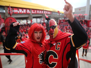 Calgary Flames fans Shari Lebel, left, and martin Brodeur cheer during the tailgate party outside the saddledome before the Flames take on the Anaheim Ducks in NHL playoff action at the Scotiabank Saddledome in Calgary, Alta. on Monday April 17, 2017. Leah Hennel/Postmedia
