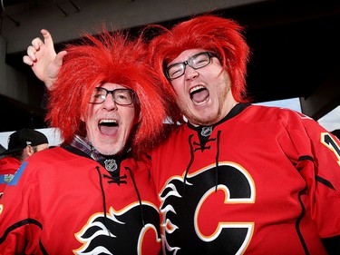 Calgary Flames fans Dan Royle, left and son Ian cheer during the tailgate party outside the saddledome before the Flames take on the Anaheim Ducks in NHL playoff action at the Scotiabank Saddledome in Calgary, Alta. on Monday April 17, 2017. Leah Hennel/Postmedia