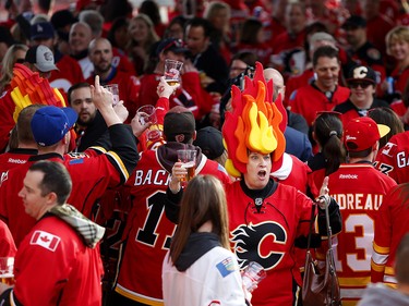 Calgary Flames fan Shauna Roth cheers with flames fans during the tailgate party outside the saddledome before the Flames take on the Anaheim Ducks in NHL playoff action at the Scotiabank Saddledome in Calgary, Alta. on Monday April 17, 2017. Leah Hennel/Postmedia