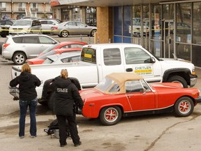 Calgary Police investigate the slaying of Rodney Conway in the parking lot of Chetlen Auto along Macleod Trail in Calgary on Saturday, April 18, 2015.