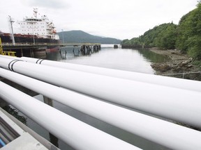 A ship receives its load of oil from the Kinder Morgan Trans Mountain Expansion Project's Westeridge loading dock in Burnaby, British Columbia, Thursday, June 4, 2015.