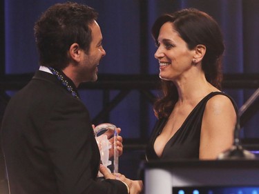 Chantal Kreviazuk (R) presents Album of the Year honor to Adam Cohen, son of the late Lenoard Cohen, during the JUNO Awards gala at the Shaw Centre in Ottawa, Canada, April 1, 2017. / AFP PHOTO / Lars HagbergLARS HAGBERG/AFP/Getty Images