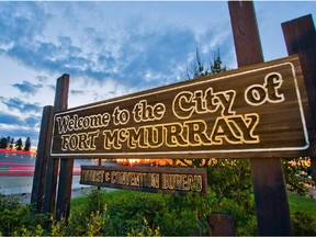 A Welcome to Fort McMurray sign stands on the side of Highway 63 on the south end of Fort McMurray, Alta. on June 19, 2013.