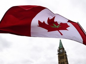 A Canadian flag with a marijuana leaf on it flies during a 4/20 rally on Parliament Hill in Ottawa, on Thursday, April 20, 2017.