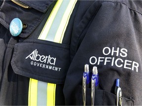 An Alberta Occupational Health and Safety officer stands at a press conference on Monday May 12, 2014 in Edmonton Alta. Tom Braid/Edmonton Sun/QMI Agency