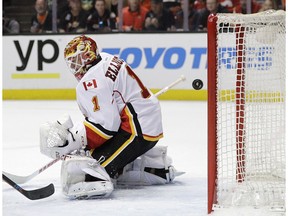The puck enters the net past Calgary Flames goalie Brian Elliott for a goal during the second period in Game 1 of a first-round NHL Stanley Cup playoff series Thursday, April 13, 2017, in Anaheim, Calif.